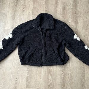women’s black sherpa with white flowers on the sleeves